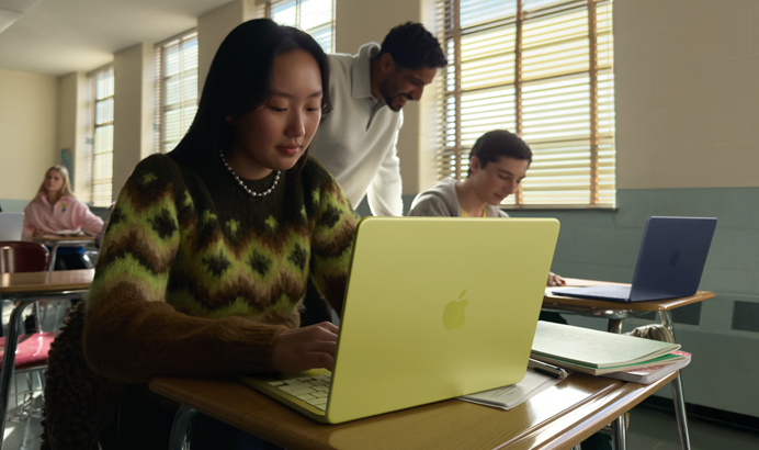 A student uses MacBook Neo, citrus colour, unplugged in a classroom setting