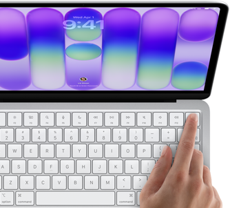 MacBook Neo, silver colour, showing login screen, person's finger on Touch ID sensor in top-right corner of keyboard