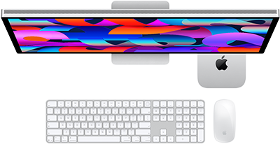 Mac mini tucked under Studio Display, Magic Keyboard with numeric keypad, Magic Mouse