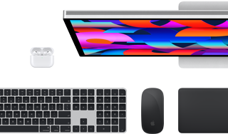 Collection of accessories and device including AirPods, Magic Keyboard with Touch ID, Magic Mouse, Magic Trackpad, Studio Display