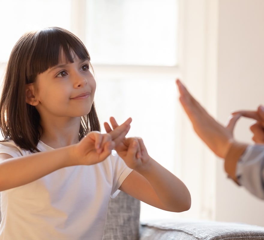 Young girl using sign language
