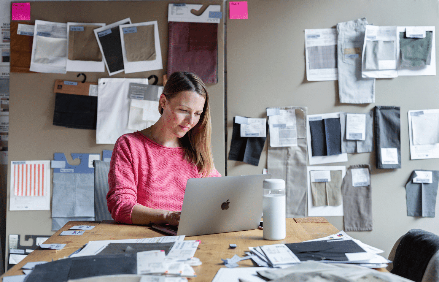 Fashion designer in office using a MacBook