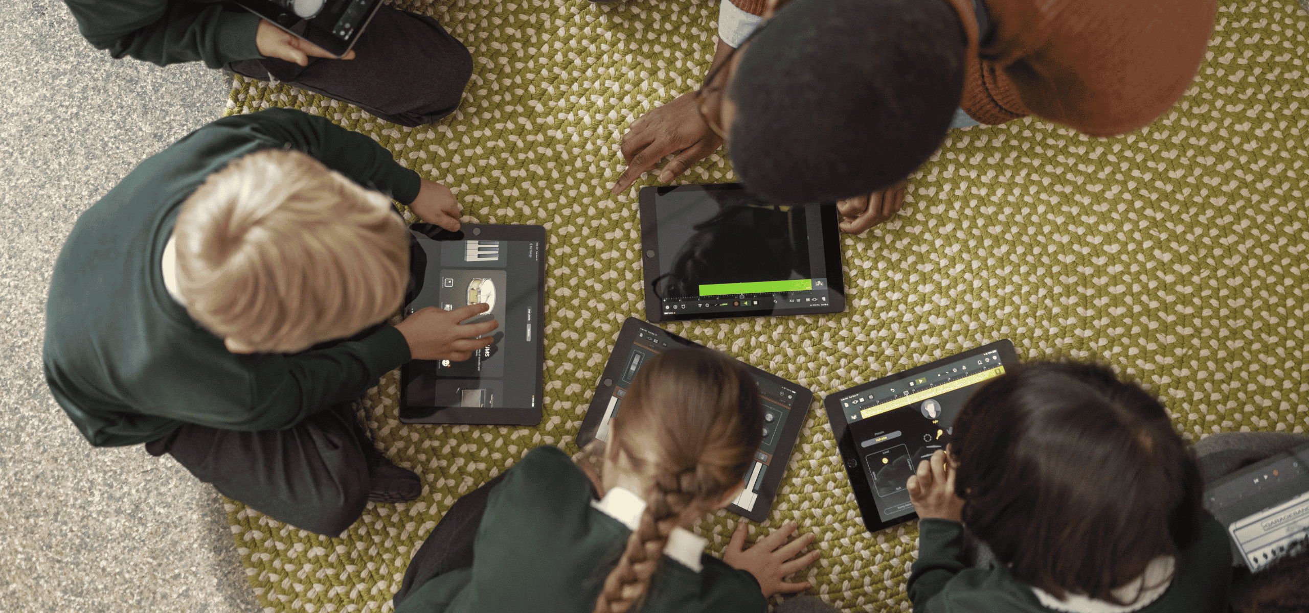 Students use iPads for a music lesson