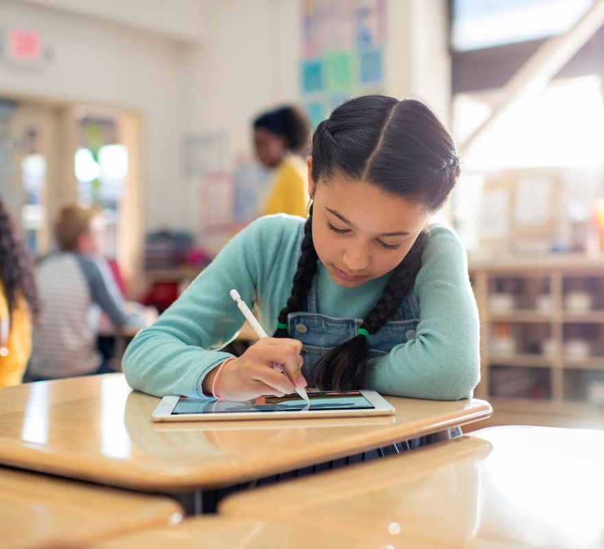 A Student using an iPad and Apple Pencil for a digital assessment.