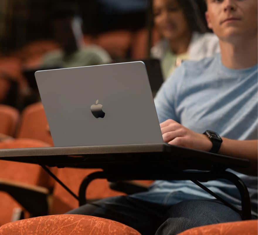 Student using Mac in a lecture hall