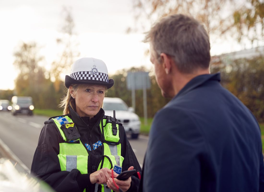 A police officer using an iPhone to take notes and file a crime report in the field.