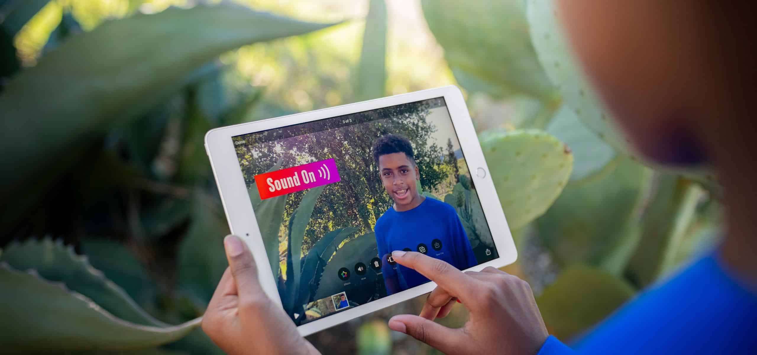 A child using an iPad to create a video for their school project.