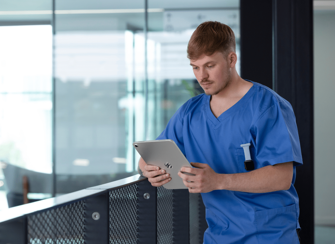 Doctor checking iPad on hospital ward