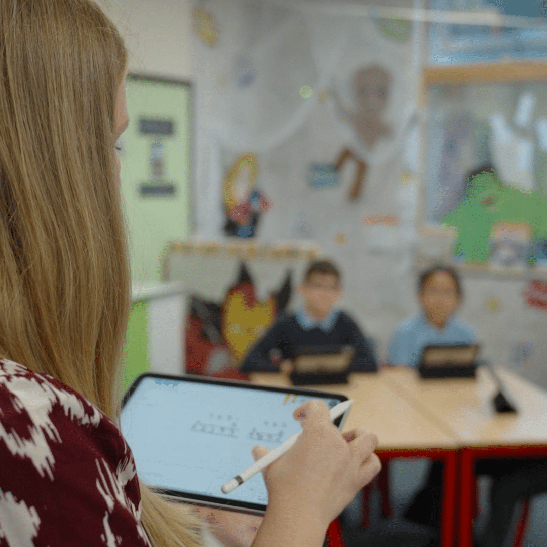 Teacher with her iPad in front of class